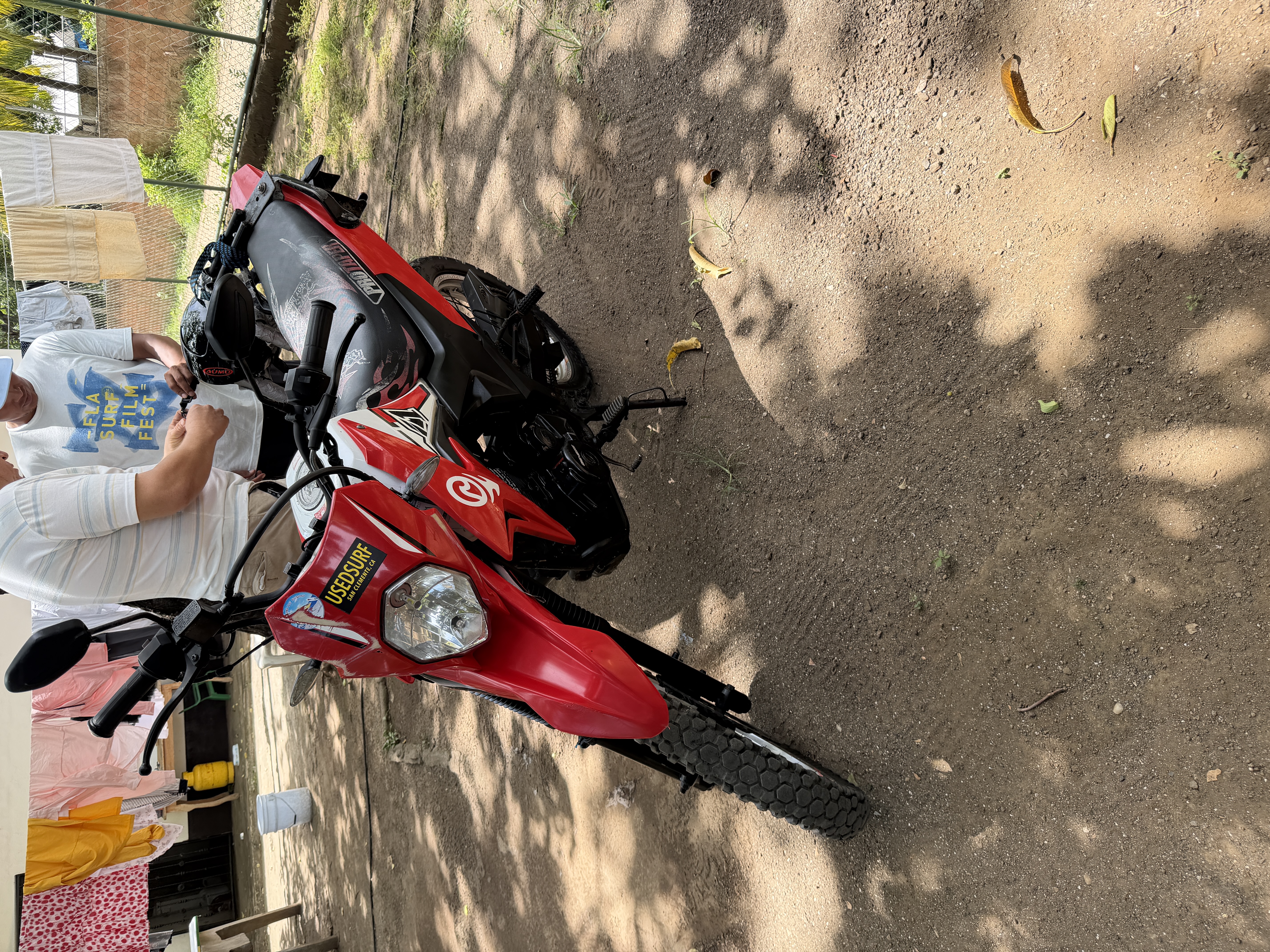 Red moto with surfboards in Nicaragua